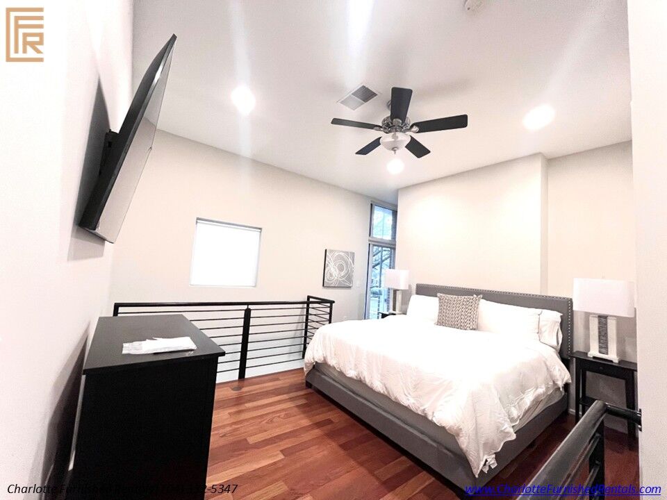 09-2084-euclid-avenue-loft-bedroom-charlotte Loft bedroom with queen bed and TV at 2084 Euclid Avenue Charlotte NC
