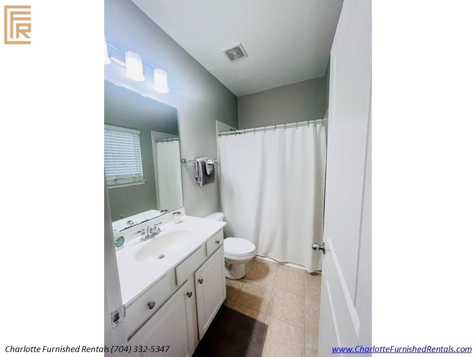 10-furnished-apartment-elizabeth-charlotte-full-bathroom Full bathroom with vanity and tub shower at 934 Gracie Way Charlotte NC