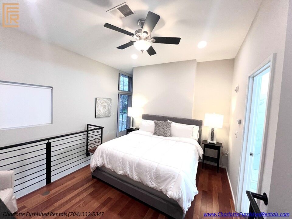 12-2084-euclid-avenue-bedroom-loft-railing Furnished bedroom with loft railing at 2084 Euclid Avenue Charlotte NC