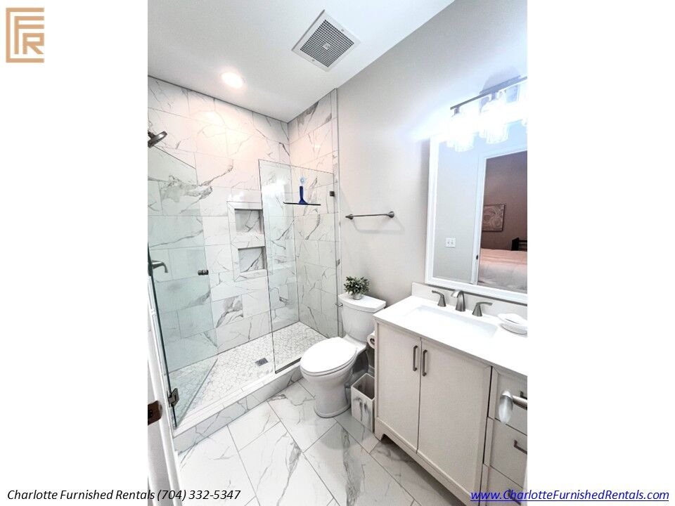 13-2084-euclid-avenue-updated-bathroom-charlotte Updated bathroom with glass shower at 2084 Euclid Avenue Charlotte NC