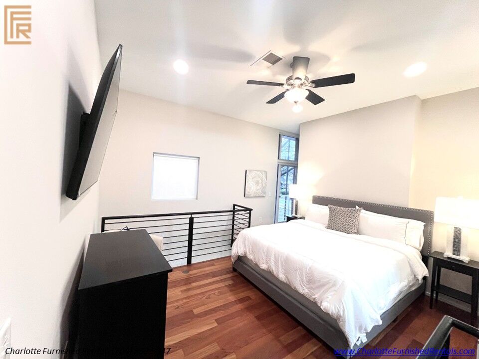 14-2084-euclid-avenue-bedroom-tv-charlotte Furnished bedroom with wall-mounted TV at 2084 Euclid Avenue Charlotte