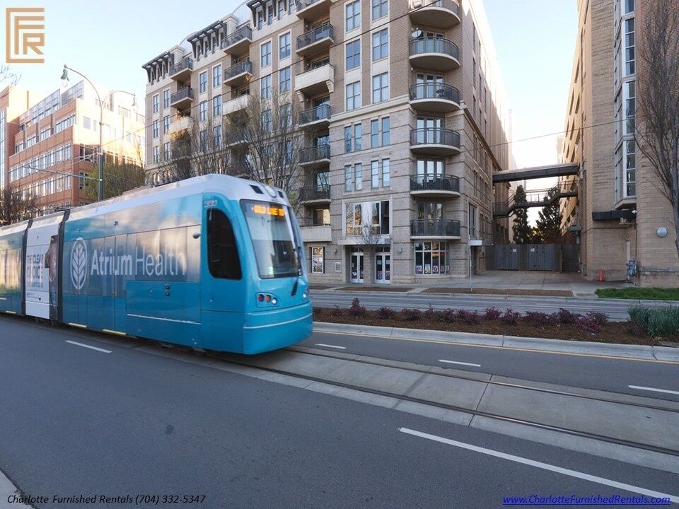 718-west-trade-unit-813-building-exterior-with-citylynx-gold-line-streetcar-uptown-charlotte-transit-access Building exterior with citylynx gold line streetcar at 718 West Trade Street Unit 813, a furnished rental in Uptown Charlotte transit access