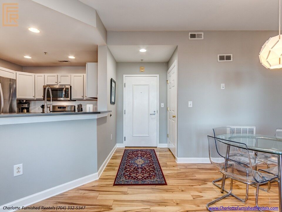 718-west-trade-unit-813-entry-dining-area-and-open-kitchen-uptown-charlotte Entry dining area and open kitchen at 718 West Trade Street Unit 813, a furnished rental in Uptown Charlotte