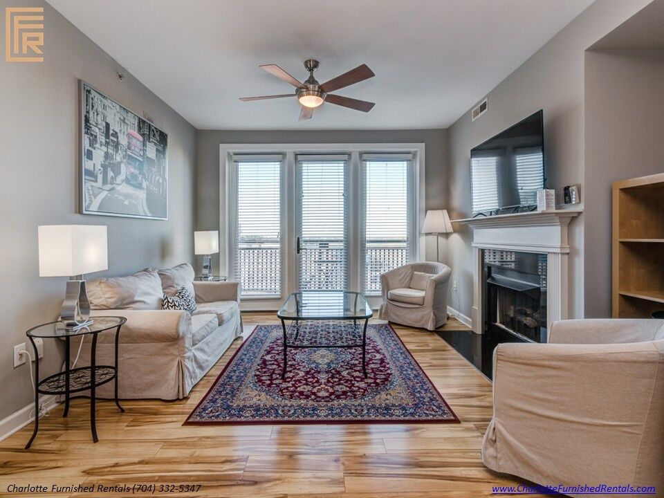 718-west-trade-unit-813-living-room-with-fireplace-uptown-charlotte Living room with fireplace at 718 West Trade Street Unit 813, a furnished rental in Uptown Charlotte