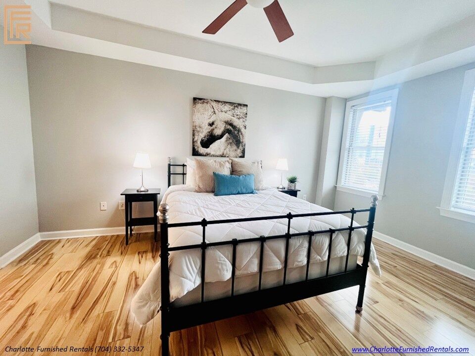 718-west-trade-unit-813-primary-bedroom-uptown-charlotte Primary bedroom at 718 West Trade Street Unit 813, a furnished rental in Uptown Charlotte