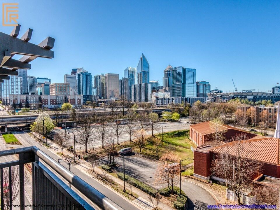 718-west-trade-unit-813-private-balcony-skyline-view-toward-bank-of-america-stadium-uptown-charlotte Private balcony skyline view toward bank of america stadium at 718 West Trade Street Unit 813, a furnished rental in Uptown Charlotte / Third Ward