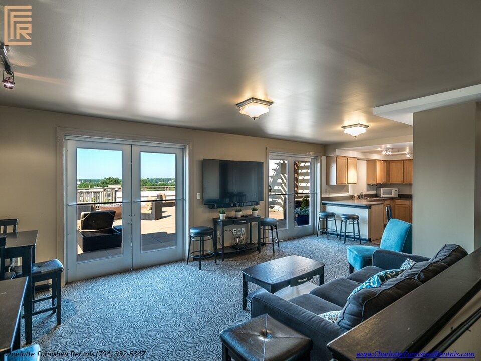 718-west-trade-unit-813-rooftop-lounge-interior-uptown-charlotte Rooftop lounge interior at 718 West Trade Street Unit 813, a furnished rental in Uptown Charlotte
