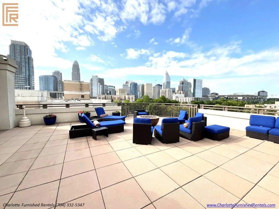 718-west-trade-unit-813-rooftop-terrace-panoramic-skyline-view-uptown-charlotte Rooftop terrace with uptown skyline view at 718 West Trade Street Unit 813, a furnished rental in Uptown Charlotte skyline