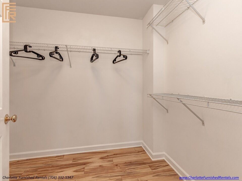 718-west-trade-unit-813-walk-in-closet-uptown-charlotte Walk-in closet at 718 West Trade Street Unit 813, a furnished rental in Uptown Charlotte
