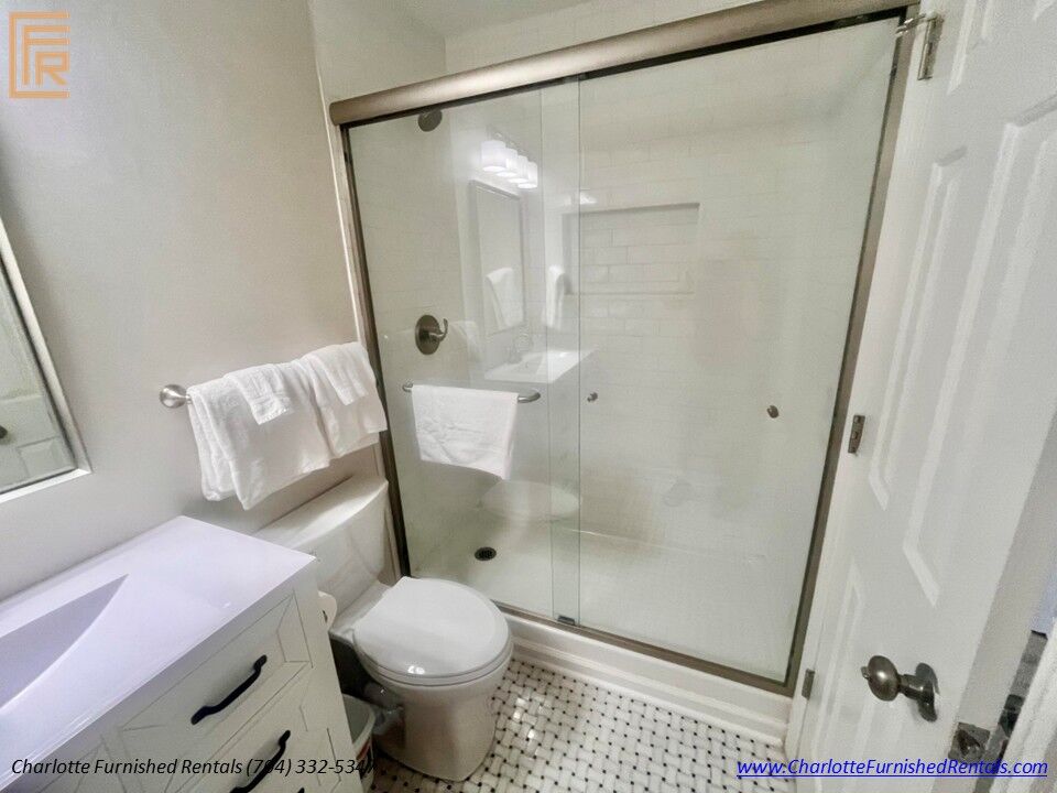 Walk-In Tile Shower Spacious walk-in closet with shelving and hanging storage.