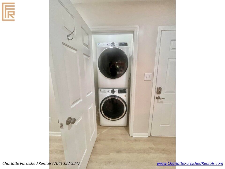 In-Unit Washer & Dryer Full-size stacked washer and dryer inside furnished SouthPark Charlotte rental.