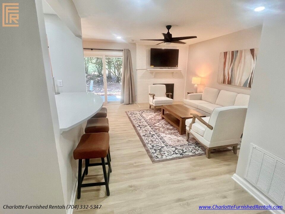 Spacious Living Room with Breakfast Bar Modern furnished living room with breakfast seating and luxury vinyl plank flooring.