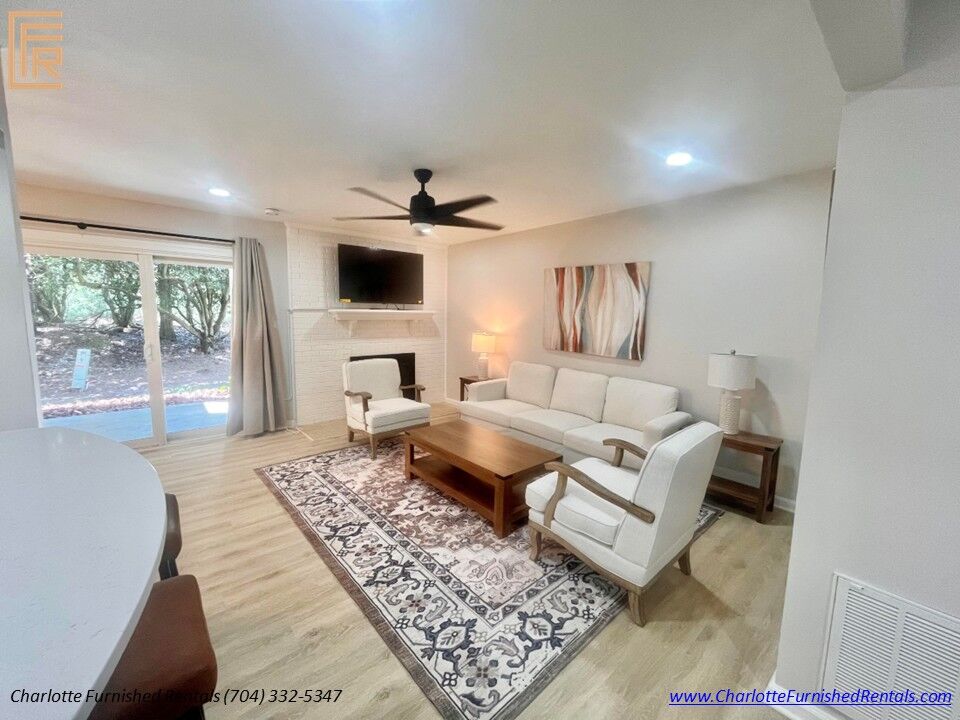 Comfortable Family Room Furnished family room with fireplace, smart TV, ceiling fan and access to outdoor patio.