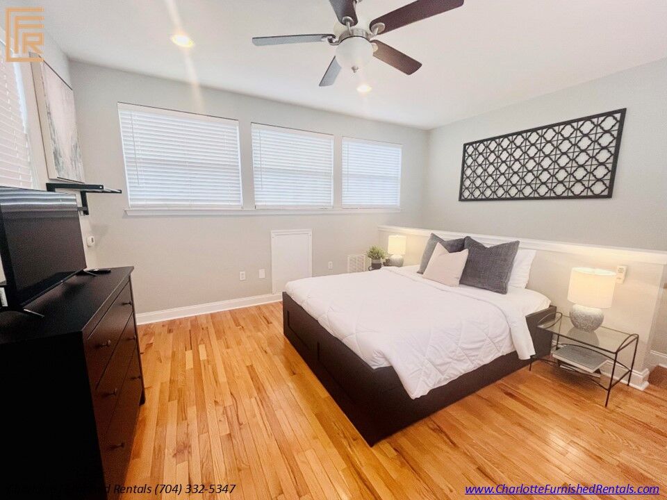 Slide7 Spacious primary bedroom with queen-size bed and premium furnishings. Comfortable bedroom featuring plush bedding and generous natural light. Primary bedroom with large closet and contemporary décor.