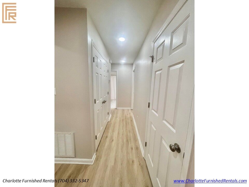Hallway Leading to Bedrooms Interior hallway with luxury flooring connecting bedrooms, bathrooms and laundry area.