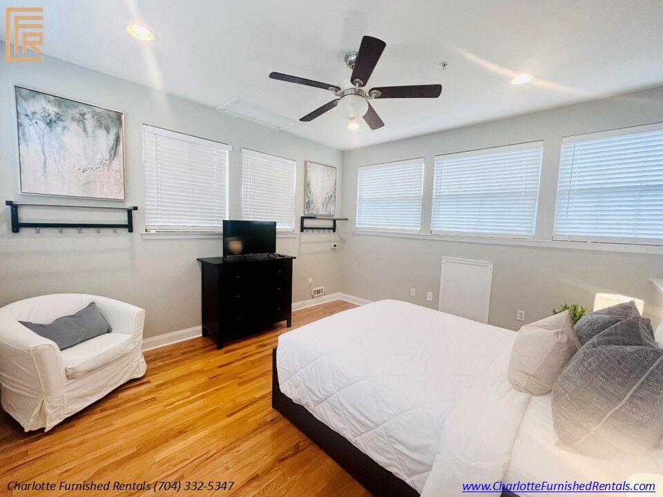 Slide8 Spacious primary bedroom with queen-size bed and premium furnishings. Comfortable bedroom featuring plush bedding and generous natural light. Primary bedroom with large closet and contemporary décor.